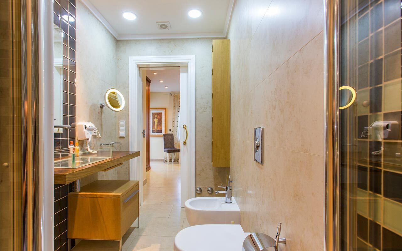 A modern bathroom with a vanity, sink, and toilet.