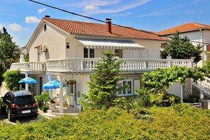Relax on the balcony with a view of lush greenery.