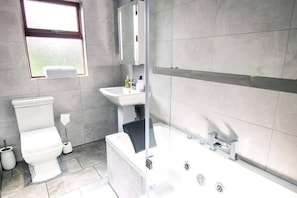 A modern bathroom with a toilet, sink, and bathtub. - Windyheads Luxury Cottage - 5 Bed 2 Bath (Fraserburgh)