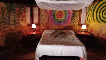 Una habitación con cama, dos mesitas de noche y dosel.
