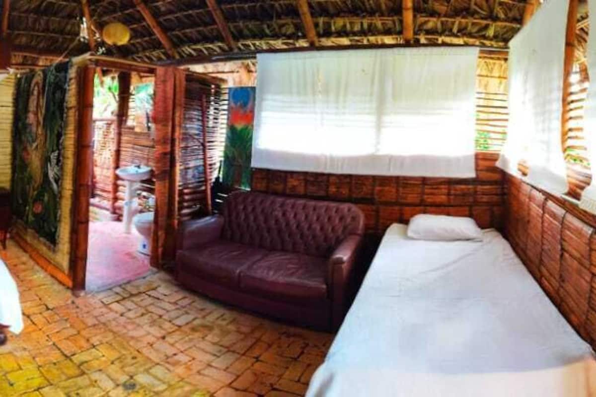 A room with a bed, a sofa, and a small table.