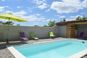 A heated pool, sun loungers