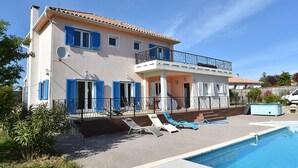 A two-story house with a swimming pool, blue shutters, and a balcony. - Beautiful Villa with Private Swimming Pool in Oupia (Oupia)