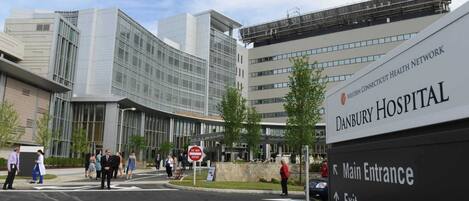 The entrance to Danbury Hospital with a clear sign indicating the main entrance and exit.