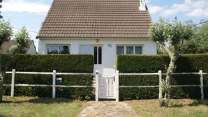 A two-story house with a tiled roof, a white door, and a white fence in front. - Saint-Germain Beach Bliss (St. Germain-Sur-Ay)
