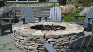 A stone fire pit surrounded by Adirondack chairs. - Condo < 1mi. from Mt. Snow / Free Shuttle (West Dover)