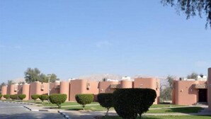 A row of uniform buildings with a clear sky. - One to One Ain Al Fayda Resort (Al Ain)