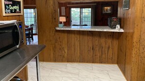A wooden interior with a kitchen counter, a microwave, and a sign that reads "Welcome to Dogwood Hill." - Private Mountain Getaway at Dogwood Hill (Rosman)