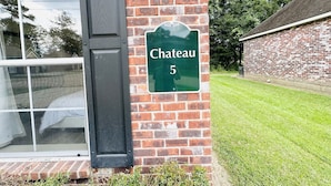 A brick building with a green sign reading "Chateau 5" on the side.