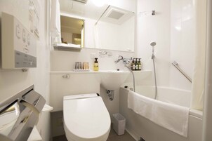 Un baño moderno con inodoro, lavamanos y ducha.