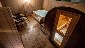 A wooden spa area with a hot tub, seating, and a wooden door. - Tabino Hotel lit Miyakojima (Miyakojima)