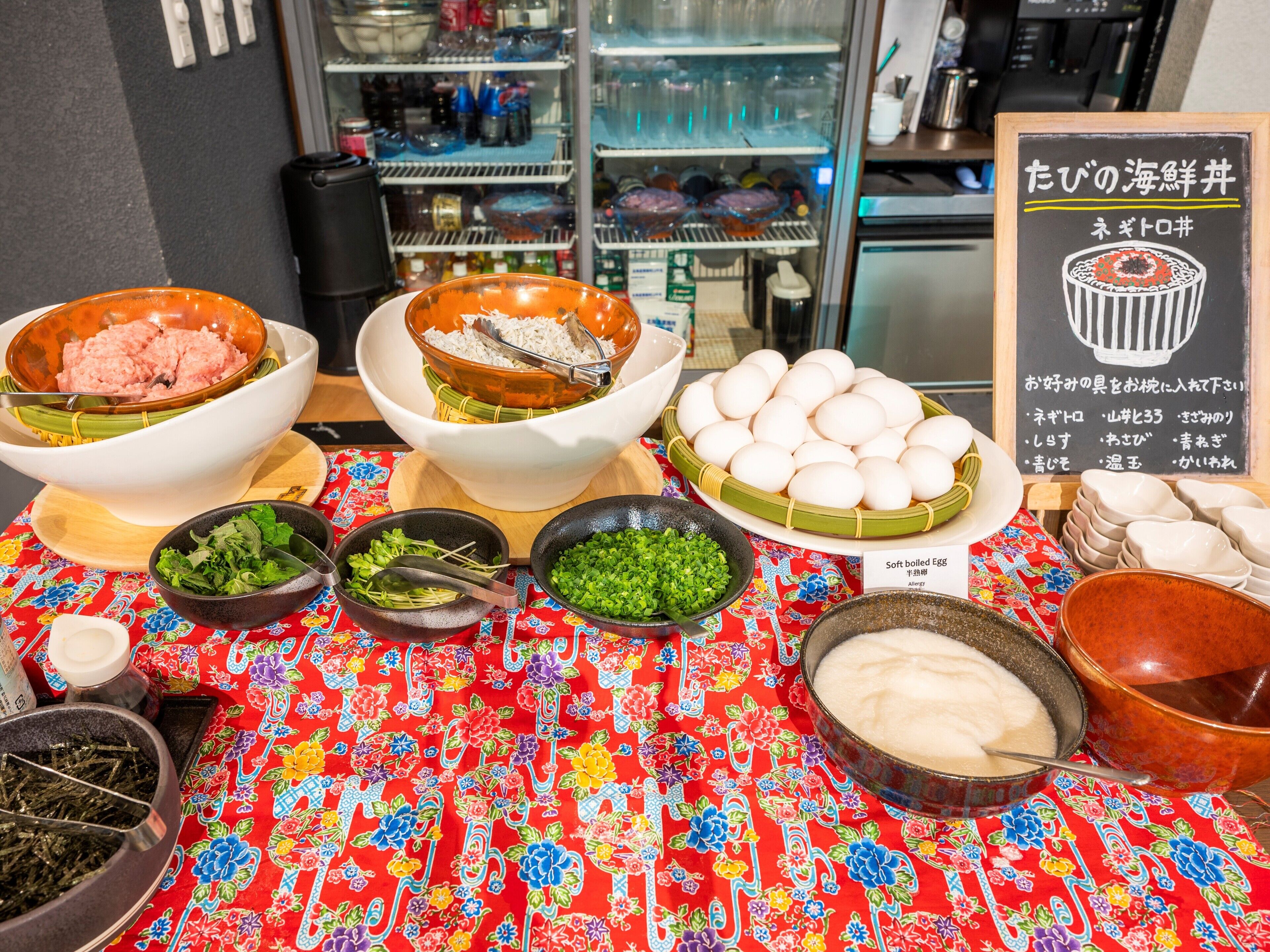 A table with various food items and a signboard.