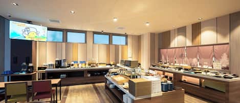 A modern breakfast buffet with multiple food stations and seating areas.