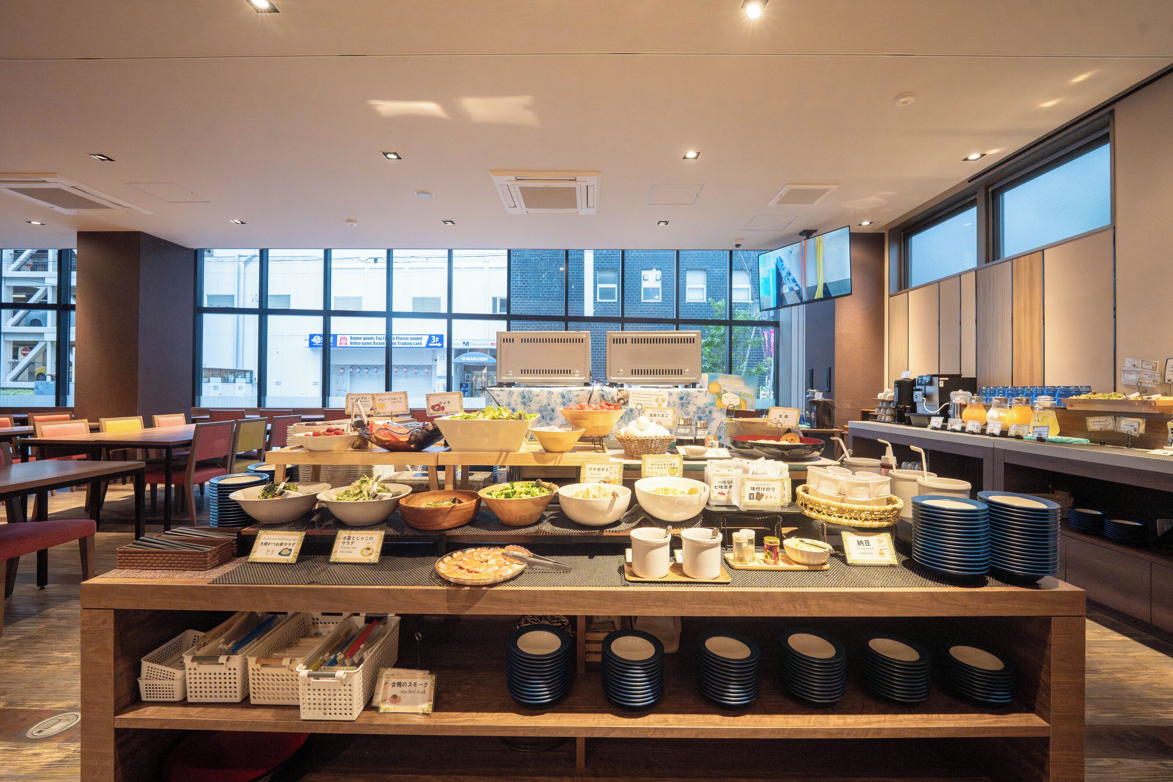 A buffet area with various food items and dishes.