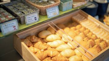 A bakery display with various baked goods and labeled containers.