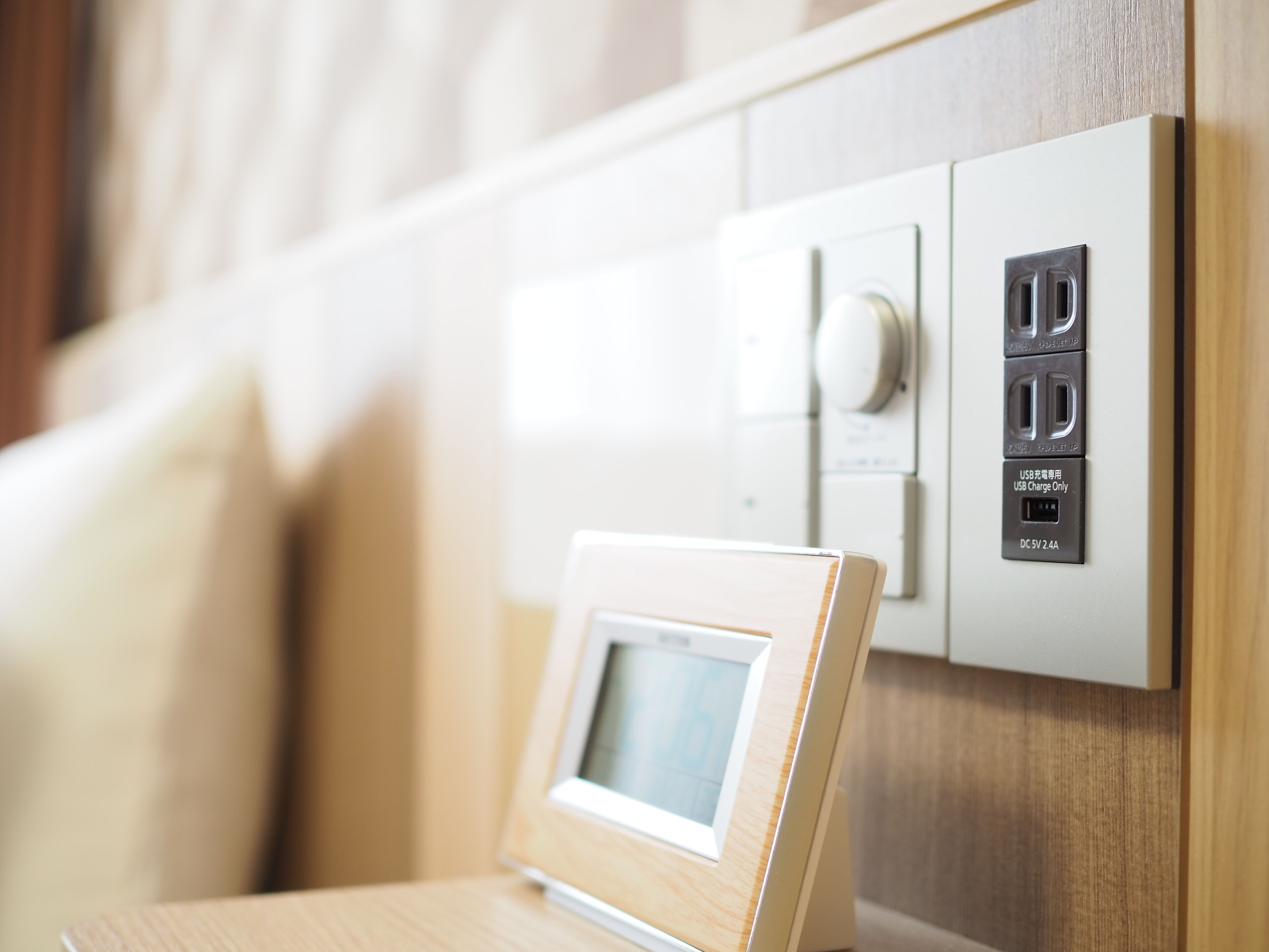 Toma de corriente en la pared con puerto de carga USB, interruptor de luz y panel de control del termostato.