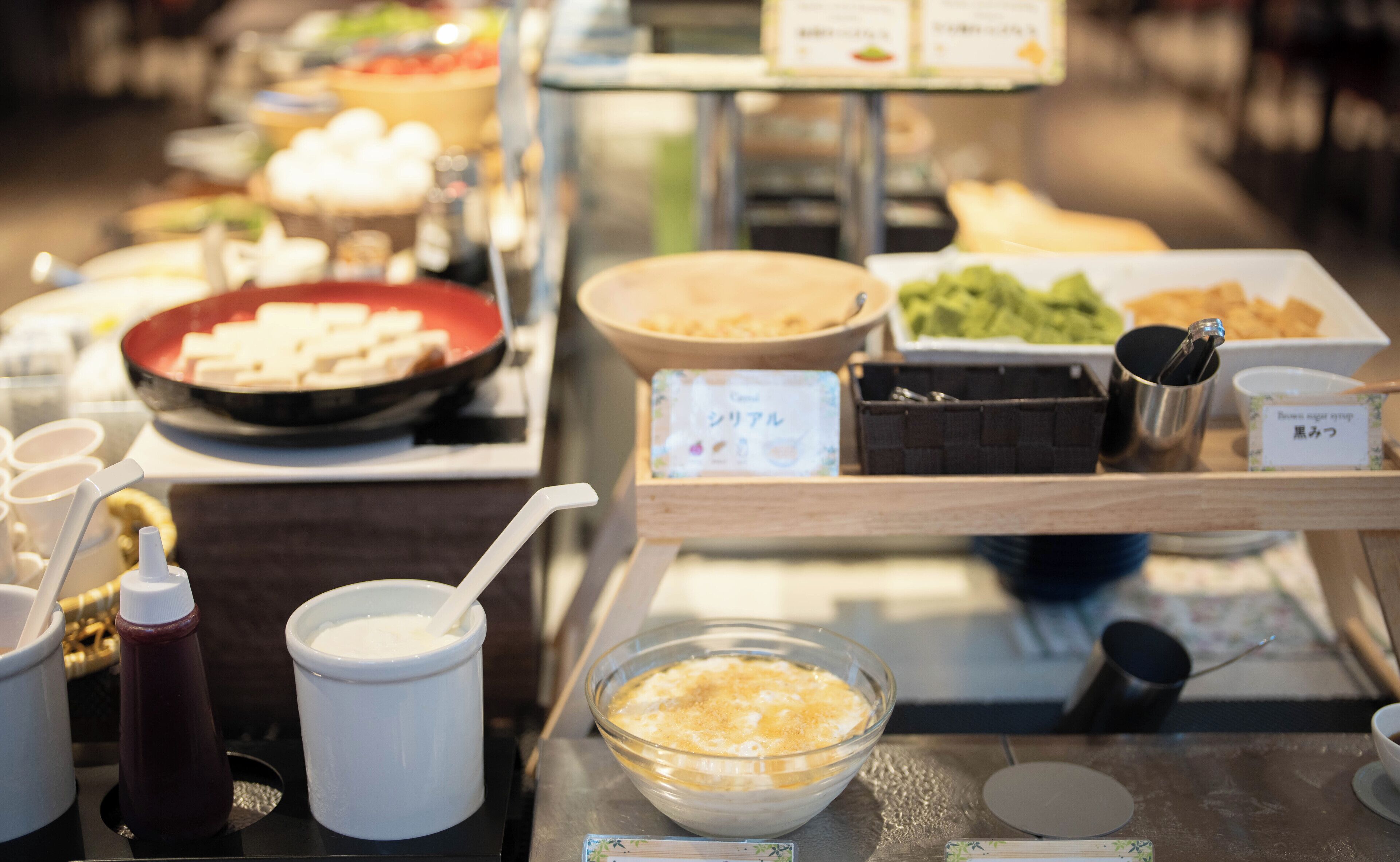 A buffet with various dishes and condiments.