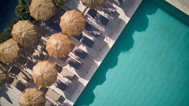 An aerial view of a poolside area with lounge chairs and thatched umbrellas. - Altura Hotel Zakynthos (Zakynthos)