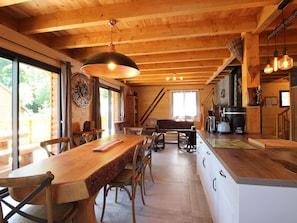 A wooden interior with a dining area, kitchen, and large windows. - Splendid 5-bedroom chalet with terrace, garage, and wifi in Mont-Dore (Mont-Dore)
