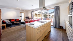 A modern living room with a central island, a dining area, and a kitchen. - Top Location Gerlos! - Lovely Apartment - 6P (Gerlos)