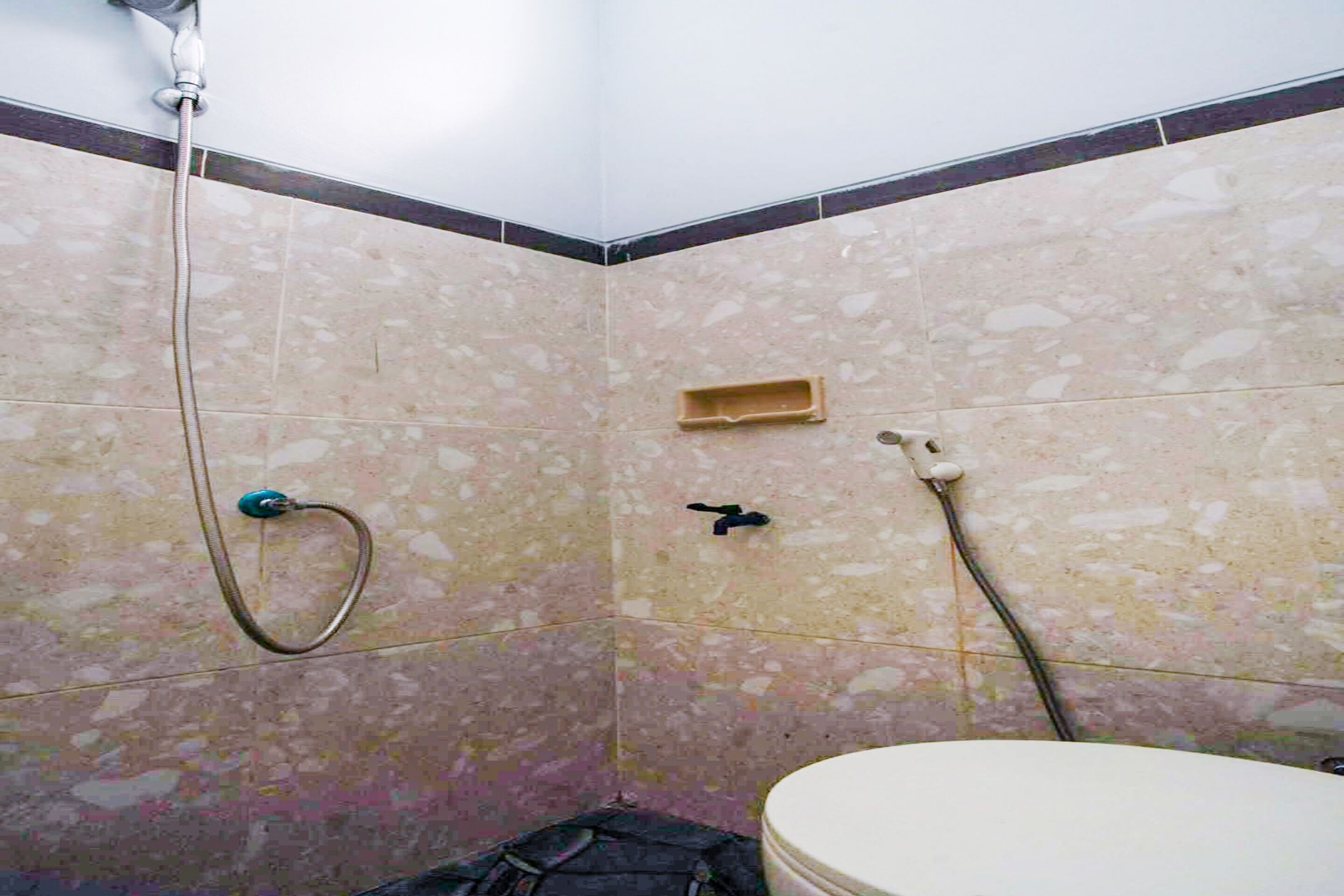 A bathroom with a shower, a toilet, and a sink.