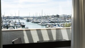 A marina filled with boats, viewed from a balcony with a railing.