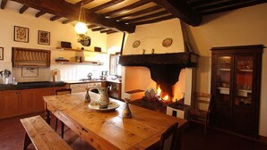 A rustic kitchen with a wooden table, bench, and a fireplace. - CORZANELLO - Charming farmhouse in the Chianti with  swimming pool use (Calzaiolo)