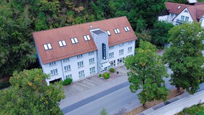 An aerial view of a hotel with a red-tiled roof, multiple windows, and a central tower labeled "HOTEL". - Taste Smart Hotel Backnang (Backnang)
