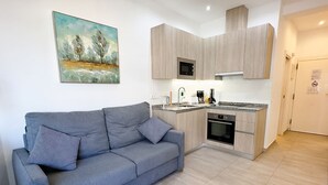 A modern kitchen with a built-in oven, microwave, and coffee maker.