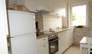 Enjoy cooking and brewing in this well-lit kitchen with oven and coffee maker.