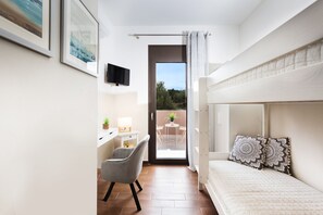 A modern bedroom with a bunk bed, a desk with a chair, a TV mounted on the wall, and a balcony with a view of greenery. - Villa Elisabeth View luxurious with POOL & BBQ !!! (CHANIA GREECE)