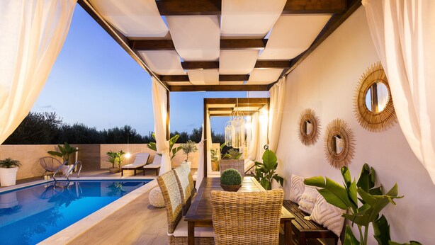A poolside area with a wooden deck, wicker furniture, and potted plants. - Villa Elisabeth View luxurious with POOL & BBQ !!! (CHANIA GREECE)