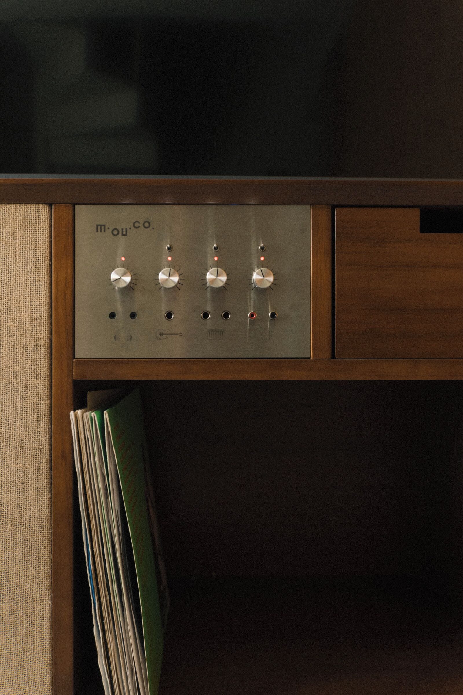 A control panel with four knobs and indicator lights, likely for adjusting audio or lighting.