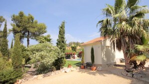 A sandy driveway leading to a building with a tiled roof, surrounded by various trees and shrubs. - Villa- Amaya - Two Bedroom Villa, Sleeps 4 (Panorama)