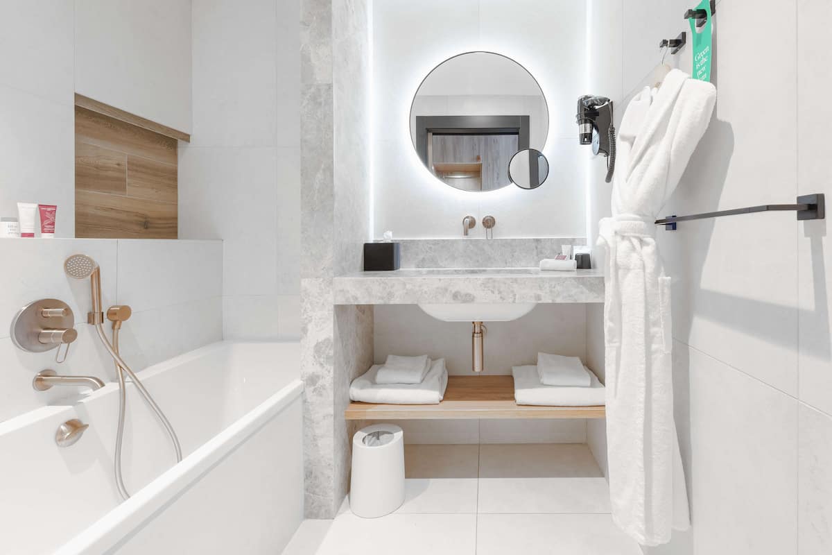 deluxe room, 1 king bed | bathroom | designer toiletries, hair dryer, towels, soap