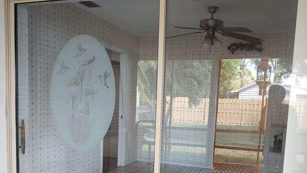 A room with a sliding glass door leading to a patio area. - Split 2 bdrm/2 full bath floorplan, All new appliances, yearly rental (Stuart)
