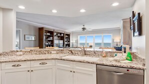 A modern kitchen with white cabinets, granite countertops, and a Bosch dishwasher. - 5508 Hampton Place - UPDATED Villa with Fantastic Oceanfront Views! (Hilton Head Island)