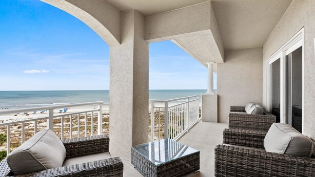 A balcony with wicker furniture and a view of the beach. - 5508 Hampton Place - UPDATED Villa with Fantastic Oceanfront Views! (Hilton Head Island)