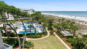 A resort with a pool area, beach access, and a building with balconies overlooking the beach. - 5508 Hampton Place - UPDATED Villa with Fantastic Oceanfront Views! (Hilton Head Island)