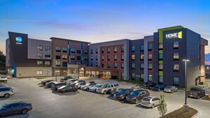 A hotel with multiple floors, a parking lot, and a sign for 'HOME 2 Suites by Hilton'. - Home2 Suites by Hilton Omaha I-80 at 72nd Street, NE (Omaha)