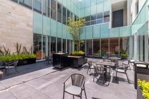 A modern outdoor patio with seating and planters.