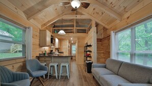 A cabin interior with a kitchen, dining area, and seating. - Lena Cabin in Chattanooga's Premier Rustic Resort (Chattanooga)