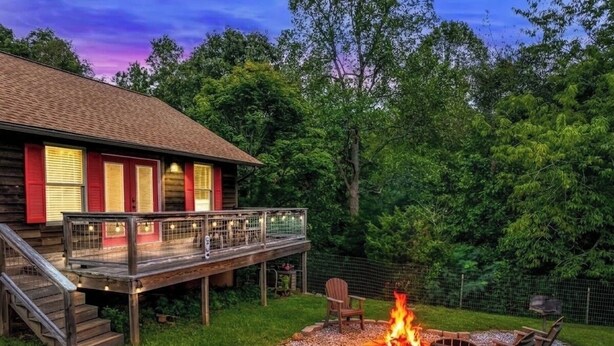 A wooden cabin with a deck, a fire pit, and outdoor seating. - Holy Smokes - 2 bdrms/2 bath, fire pit, pet friendly with yard (Townsend)