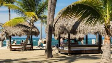 Relax in shaded comfort with ocean views and beachside seating areas.