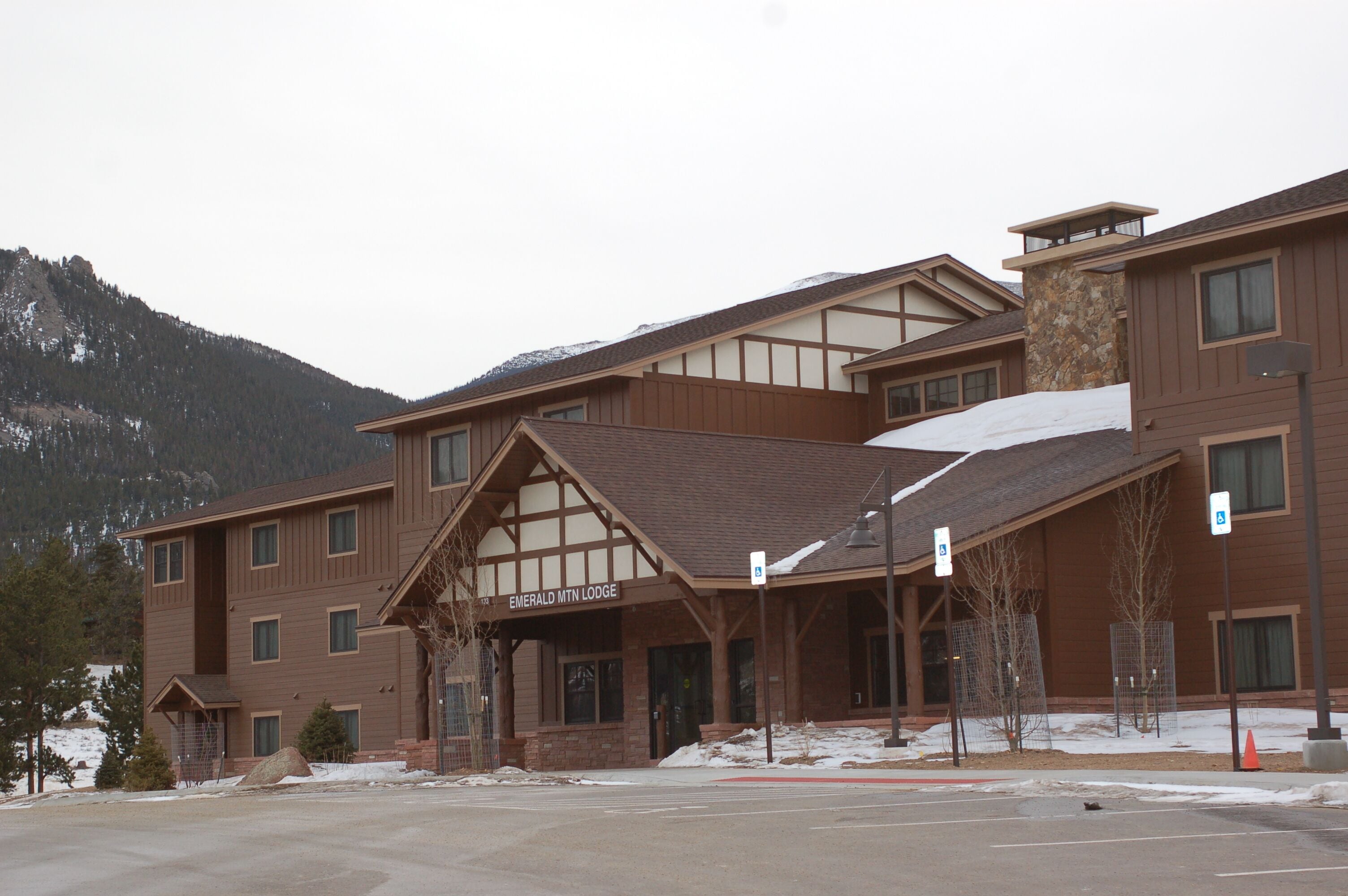 A multi-story lodge with a prominent entrance and a sign reading "Emerald MT Lodge".