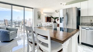 A modern kitchen with a large island, stainless steel appliances, and a view of the city. - Welcome to the paradises 
Departure clean included. Adv. #034724w10370b (Fort Myers Beach)