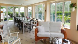 A spacious room with a dining area, a white sofa, and a glass table with a decorative bowl. - Beautiful private villa for 13 guests with A/C, private pool, WIFI, TV and patio (Alcover)