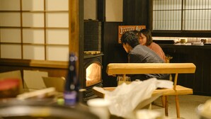 A cozy restaurant interior with a wooden bench, a brick fireplace, and a sign reading "Jittery Joe's". - The Ninja Mansion (Toyota)
