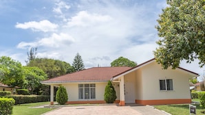 A single-story house with a tiled roof, a covered porch, and a paved driveway. - Cozy and Warm 3-bed Bungalow in Athi River (Athi River)