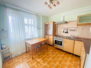 Enjoy cooking in this well-equipped kitchen with a central island, oven, and stovetop.